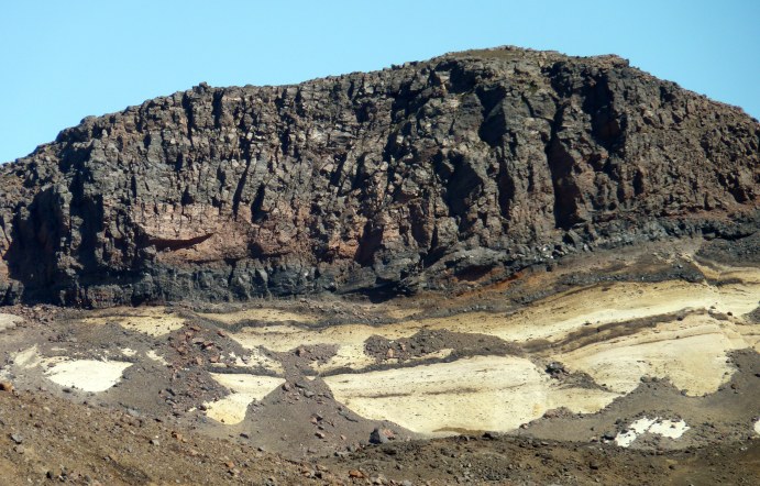 Pyroclastic deposits (pale) erupted into a vault within the ice at the start of the eruption. Subsequently capped by agglutinate (welded pyroclasts) and lava-forming effusions as explosive activity waned. 
